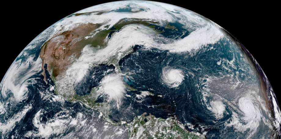 The disturbance headed for Texas can be seen in this enhanced satellite image provided by NOAA that shows Hurricane Florence, third from right, in the Atlantic Ocean on Sunday, Sept. 9, 2018. At right is Tropical Storm Helene, and second from right is Tropical Storm Isaac. (NOAA via AP) Photo: Associated Press