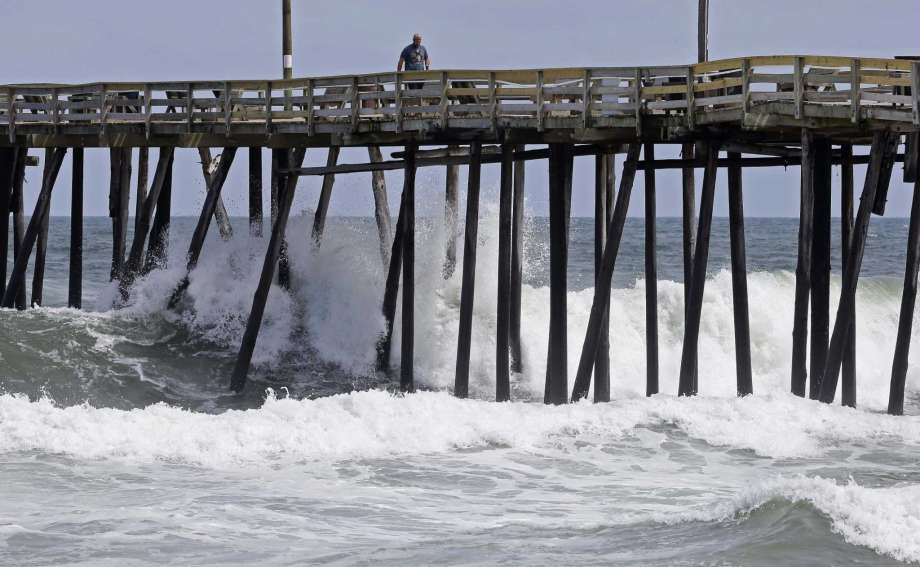 Waves crash under a pier in Kill Devil Hills, N.C., Wednesday, Sept. 12, 2018, as Hurricane Florence approaches the east coast. Photo: Gerry Broome, AP / Copyright 2018 The Associated Press. All rights reserved