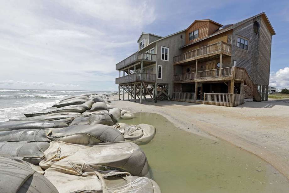 Sand bags surround homes on North Topsail Beach, N.C., Wednesday, Sept. 12, 2018 as Hurricane Florence threatens the coast. Photo: Chuck Burton, AP / Copyright 2018 The Associated Press. All rights reserved
