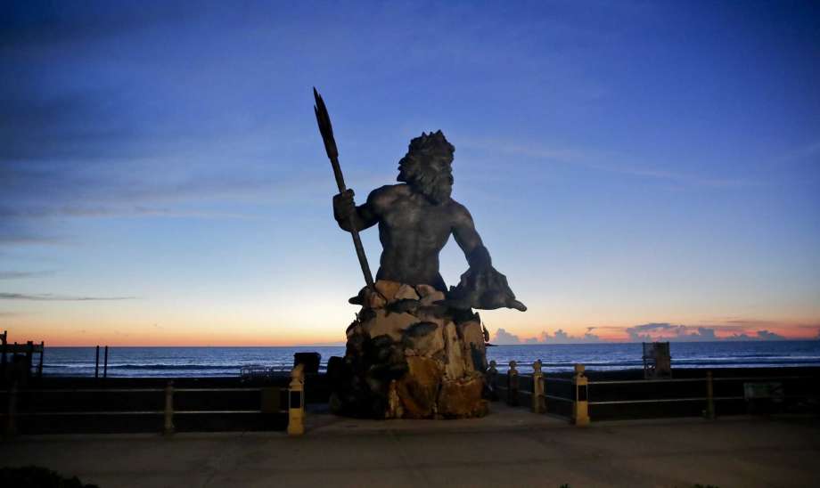 The bronze statue of Neptune stands with the sunrise behind, Wednesday, Sept. 12, 2018, in Virginia Beach, Va., as Hurricane Florence moves towards eastern shore. Photo: Alex Brandon, AP / Copyright 2018 The Associated Press. All rights reserved.