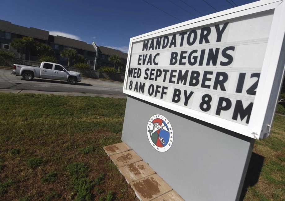 A sign warns residents about the mandatory evacuation in front of Wrightsville Beach Park in Wrightsville Beach, N.C., Wednesday, Sept. 12, 2018. The effects of Hurricane Florence in Southeastern North Carolina are expected to begin Thursday. (Matt Born/The Star-News via AP) Photo: Matt Born, AP / The Star-News