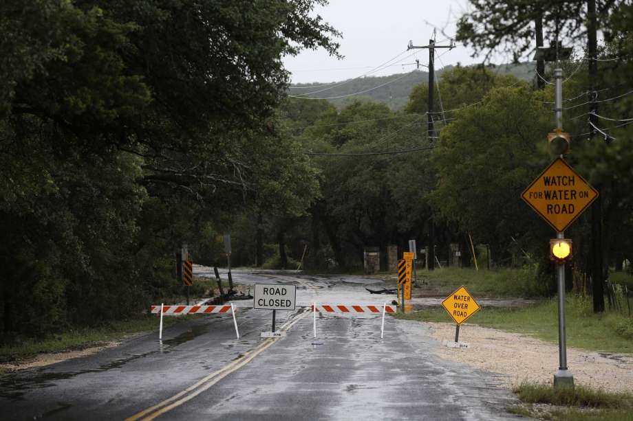 Barricades are in place on Scenic Loop Road near Gray Forest Bexar County, Sunday, Sept. 9, 2018. Heavy rains caused flooding leading to the closures of all of the roads in Grey Forest. Photo: JERRY LARA, San Antonio Express-News / © 2018 San Antonio Express-News