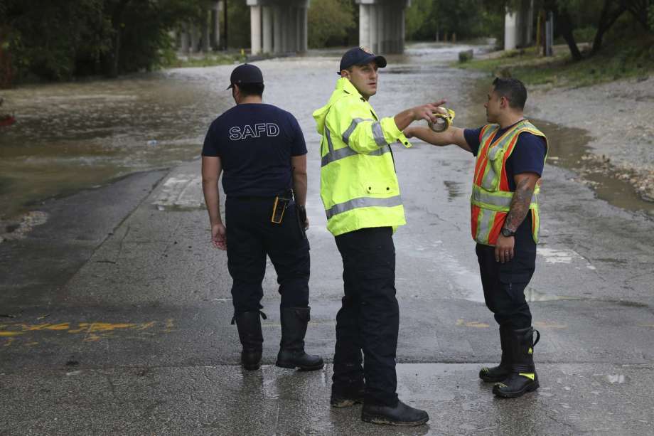 San Antonio Fire Department personnel close off Holbrook at Salado Creek , Sunday, Sept. 9, 2018. Heavy rains caused the closure of over 70 streets in the county. Photo: JERRY LARA, San Antonio Express-News / © 2018 San Antonio Express-News