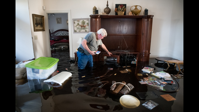 Billy Hardee removes valuables from his home as floodwater caused by Hurricane Florence rises at Aberdeen Country Club in Longs, South Carolina. Floodwaters are expected to rise through the weekend in the area. (Photo by Sean Rayford/Getty Images)