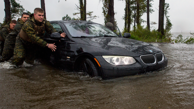 Marines with Marine Corps Base Camp Lejeune help push a car out of a flooded area during Hurricane Florence, on Marine Corps Base Camp Lejeune, Sept. 15, 2018. (Photo courtesy of U.S. Marine Corps/Lance Cpl. Isaiah Gomez)