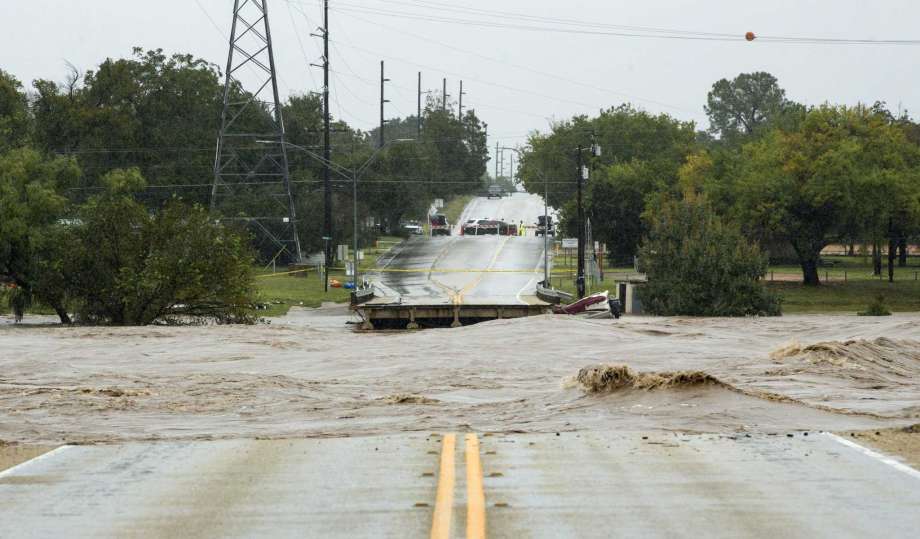 The Llano River flows between to sides of Ranch Road 2900 after the bridge was washed out due to flooding Tuesday, Oct. 16, 2018, in Kingsland, Texas. (Jay Janner/Austin American-Statesman via AP) Photo: Jay Janner, Associated Press / Austin American-Statesman