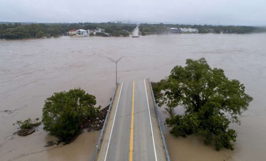 The Llano River flows between the washed out Ranch Road 2900 bridge, Tuesday, Oct. 16, 2018, in Kingsland, Texas. (Jay Janner/Austin American-Statesman via AP) Photo: Jay Janner, Associated Press / Austin American-Statesman