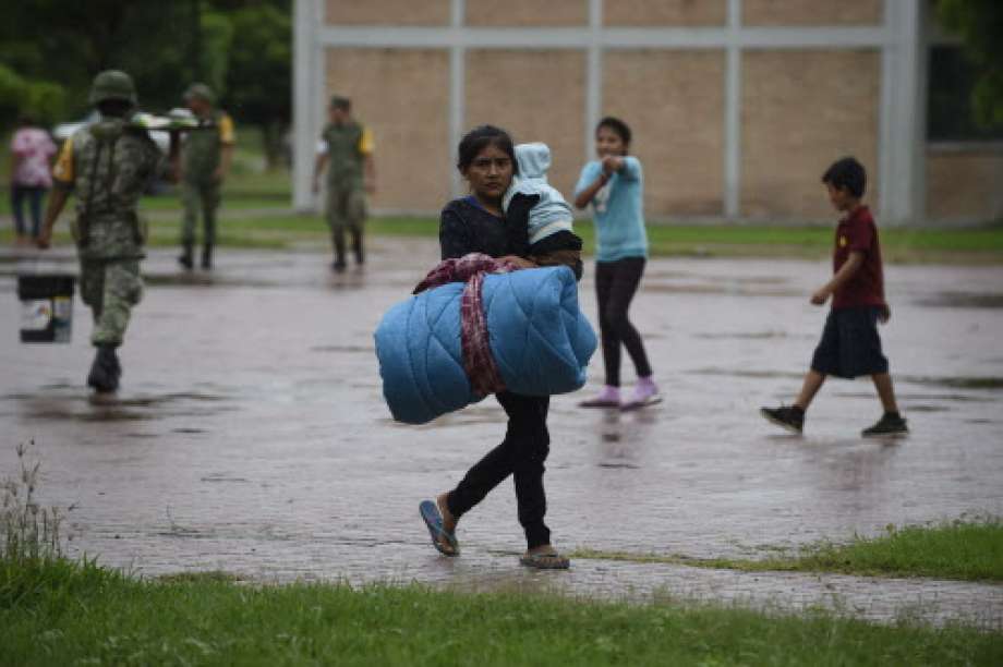 A woman carries her baby at an improvised shelter in Escuinapa, Sinaloa state, Mexico, on October 23, 2018, before the arrival of Hurricane Willa.&nbsp; Photo: ALFREDO ESTRELLA, AFP/Getty Images / AFP or licensors