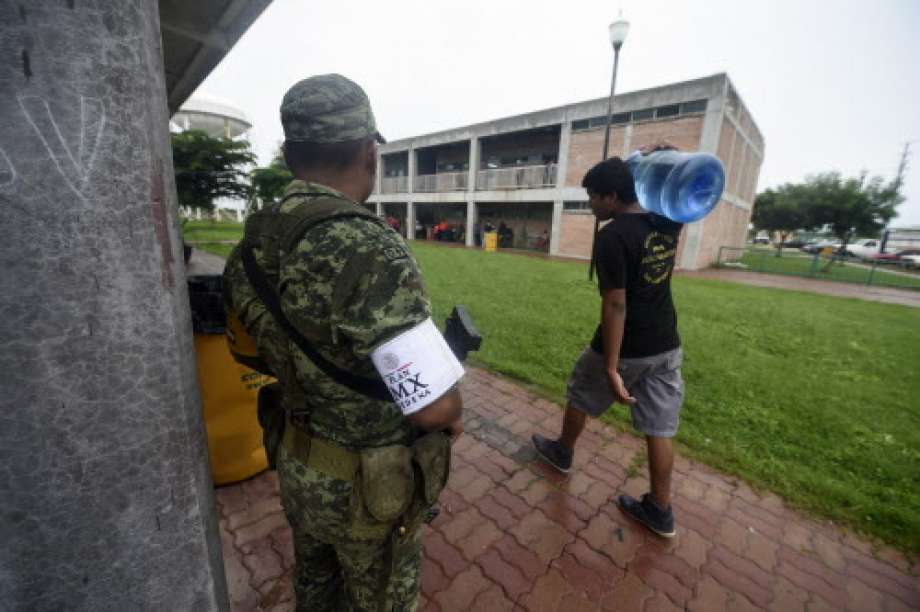 A soldier stands guard at an improvised shelter in Escuinapa, Sinaloa state, Mexico, on October 23, 2018, before the arrival of Hurricane Willa.  Photo: ALFREDO ESTRELLA, AFP/Getty Images / AFP or licensors
