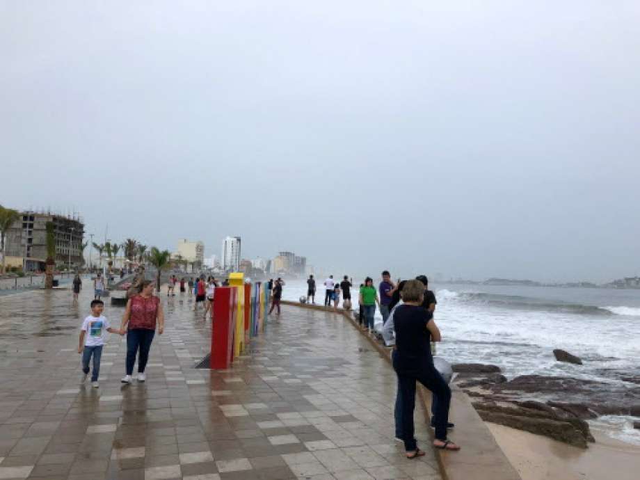 Tourists walk along the coastline of Mazatlan, Sinaloa state, Mexico on October 23, 2018, before the arrival of Hurricane Willa.  Photo: DANIEL SLIM, AFP/Getty Images / AFP or licensors