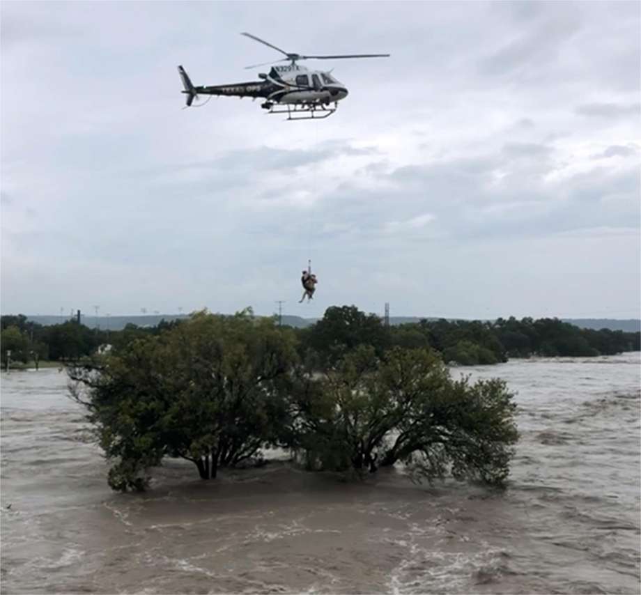 Texas DPS helicopter crew extracts a person who sought refuge in a tree as the South Llano and Llano rivers near Junction flooded early Monday. The flooding caused temporary closure of a handful of Hill Country state parks including popular South Llano River State Park. Photo: Texas Parks And Wildlife Department, HOGP / Texas Parks And Wildlife Department / Texas Parks and Wildlife department