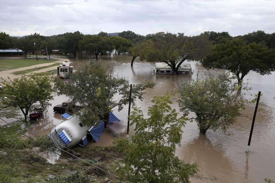 Recreation vehicles are seen strewn about at the South Llano River RV Park &amp; Resort in Junction on Monday. Heavy rains the area caused the Llano River to flood and about 19 people were rescued. One woman swept away by floodwaters drifted more than 20 miles before she was rescued, according to the Texas A&amp;M Forest Service. Photo: Jerry Lara /Staff File Photo / © 2018 San Antonio Express-News