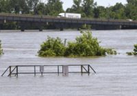 Record floods breach Arkansas levee, overtop 2 in Missouri