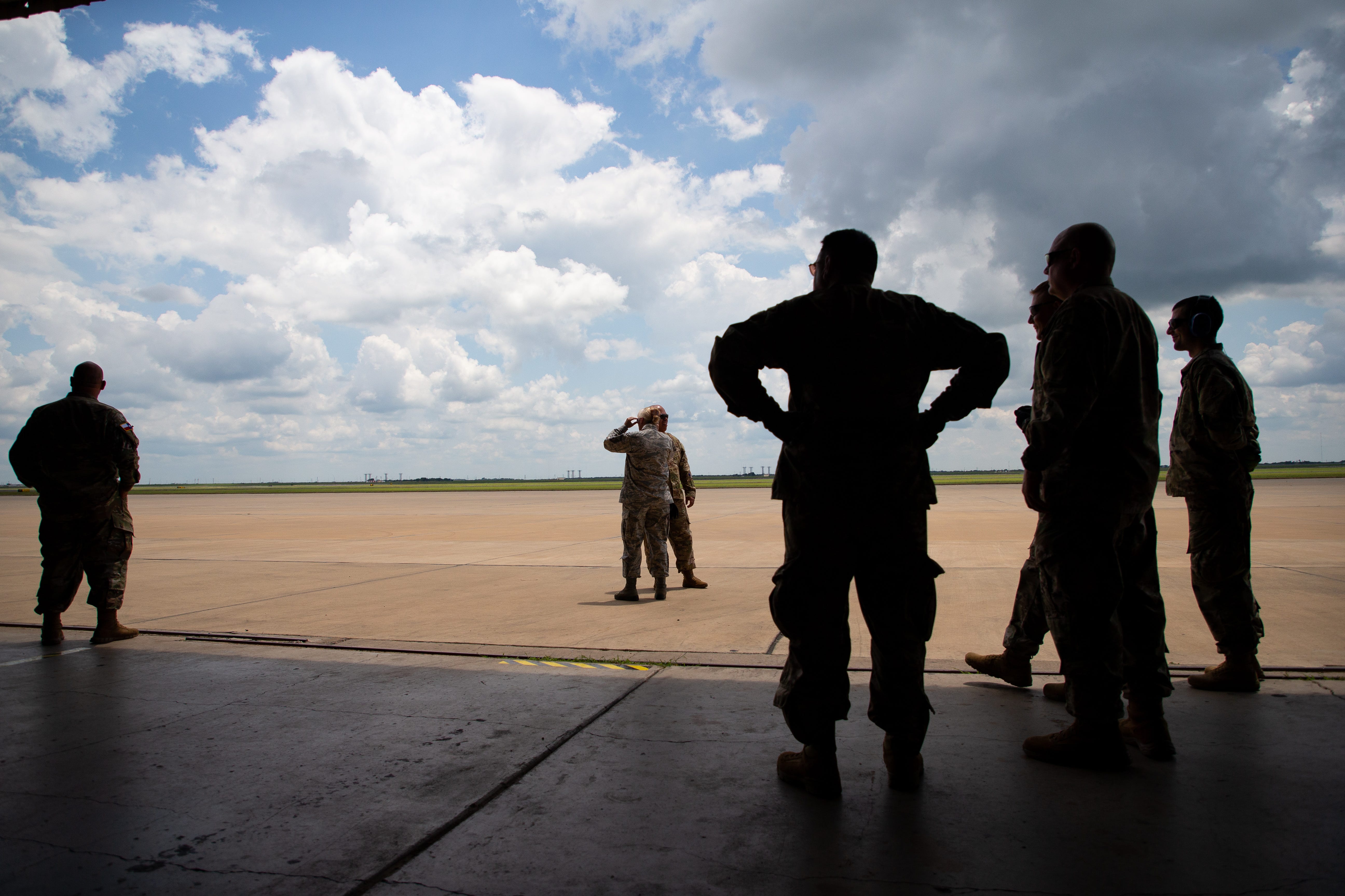 Members of the Texas State Guard watch as a C-130 lands for a hurricane air emergency evacuation drill involving with the Texas Air National Guard at the Corpus Christi International Airport on Wednesday, June 12, 2019. 