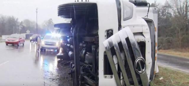 Mail truck blown onto it side by powerful winds