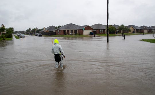 A man walks down a flooded Annemasse Street on Monday, June 1, 2020. 
