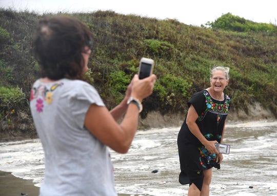 Jenny Heal, right, and Claire Schroer go to the beach in Port Aransas to see the waves before Hurricane Hanna landfall. Both are from Austin and this is their first hurricane.