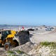 A front end loader places sand to block vehicle access near Bob Hall Pier beach on Thursday, July 16, 2020. Nueces County Judge Barbara Canales issued an order prohibiting vehicle access on beaches until August 1.