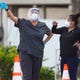 Healthcare workers conduct COVID-19 testing in the parking lot at the American Bank Center on Thursday, Aug. 6, 2020.