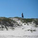 A man stands on the sand, Saturday, May 2, 2020, in Port Aransas. Gov. Greg Abbott first phase to reopen Texas began Friday, May 1.