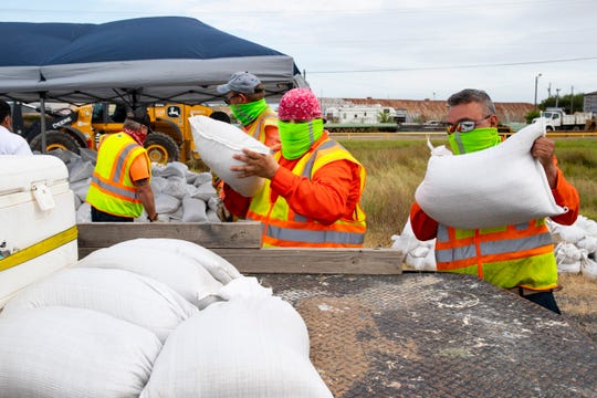 Employees with the city of Corpus Christi load sandbags into residents' vehicles as Tropical Storm Hanna approached on Friday, July 24, 2020.
