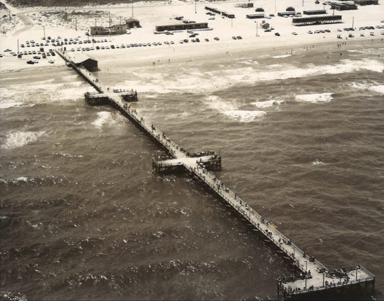Bob Hall Pier on North Padre Island in June 1965. The wooden pier was 1,200 feet long and featured 3 T sections. Hurricane Beulah in 1967 knocked off the last 600 feet of the pier.