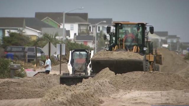 Neighborhoods still working to clear all that sand created by Isaias