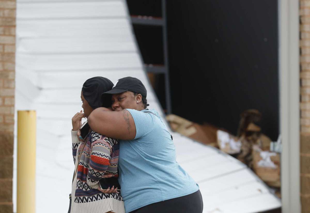 Martha Berry, right, reacts after the building housing her gym business was destroyed by a possible tornado near South Houston Ave, Sunday, Jan. 9, 2022, in Humble, Texas. (Jason Fochtman/Houston Chronicle via AP)