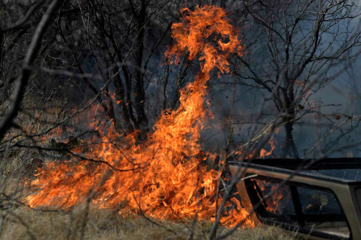 Flames quickly spread through dry grass west of Abilene, Texas near Old Highway 80 Thursday, March 17, 2022. The grass fire quickly spread southeast, jumping the roadway, continuing in the same direction until it jumped South First Street and threatened a mobile home park which was evacuated. (Ronald W. Erdrich/The Abilene Reporter-News via AP)