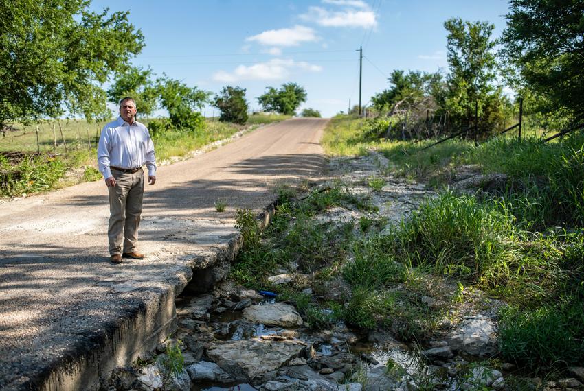 Coryell County Judge Roger Miller poses for a photo near a creek at low water crossing on Thursday, May 12, 2022 in Gatesvil…