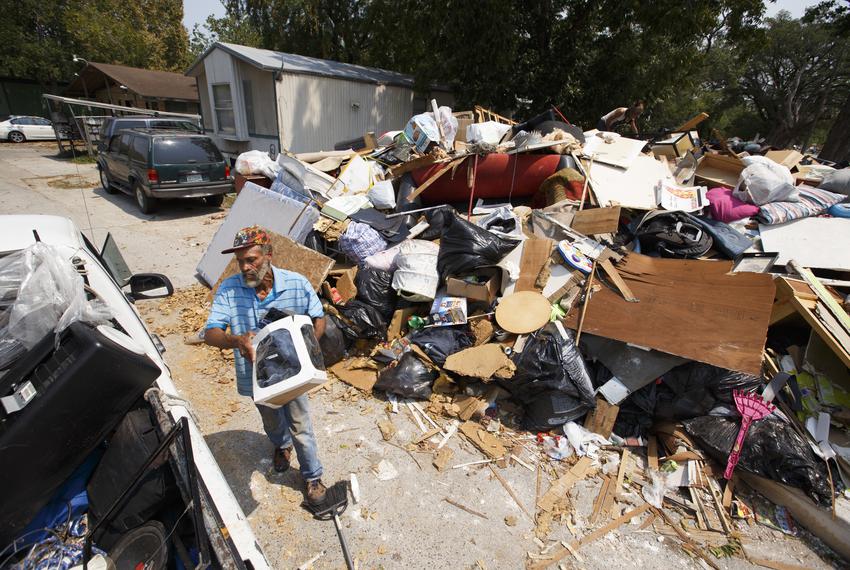 Red Stewart salvages useful items from a flood pile at a trailer park on the north side of  Houston along Gulf Bank Road Wed…