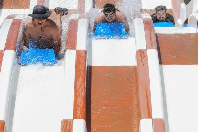 Guests slide down the Storm Chaser at Hurricane Alley Waterpark Saturday, May 28, 2022.