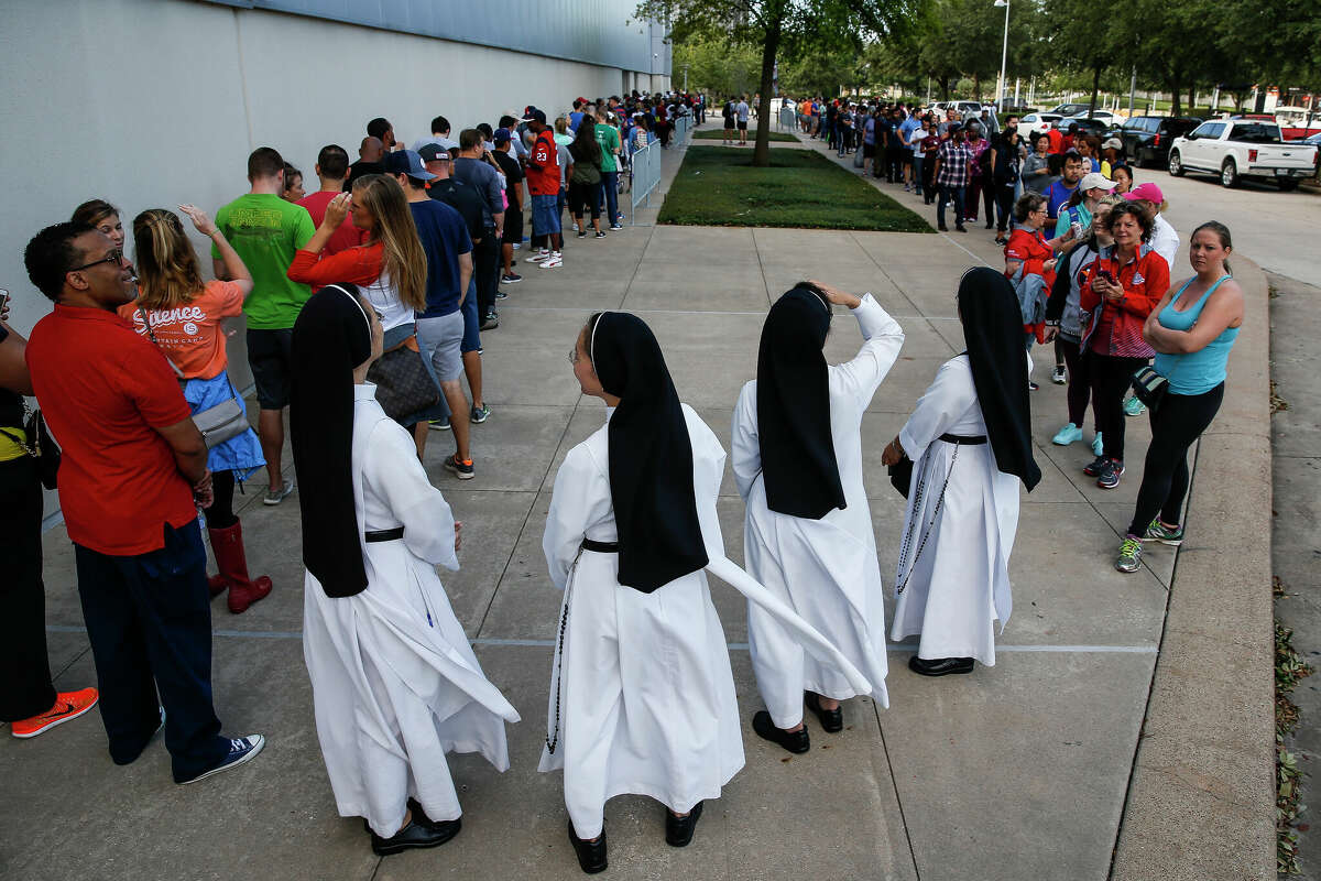 Dominican Sisters of Mary Immaculate Province join a line of people waiting to volunteer at NRG Center, which opened its doors to a capacity of 10,000 evacuees on Wednesday, Aug. 30, 2017 in Houston.