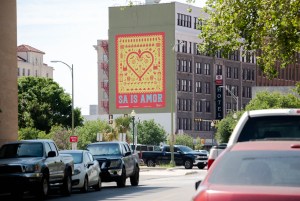 The SA Is Amor mural faces Broadway Street as people arrive to downtown. The four story artwork created by Suzy Gonzales is part of the Art Everywhere project by Centro.
