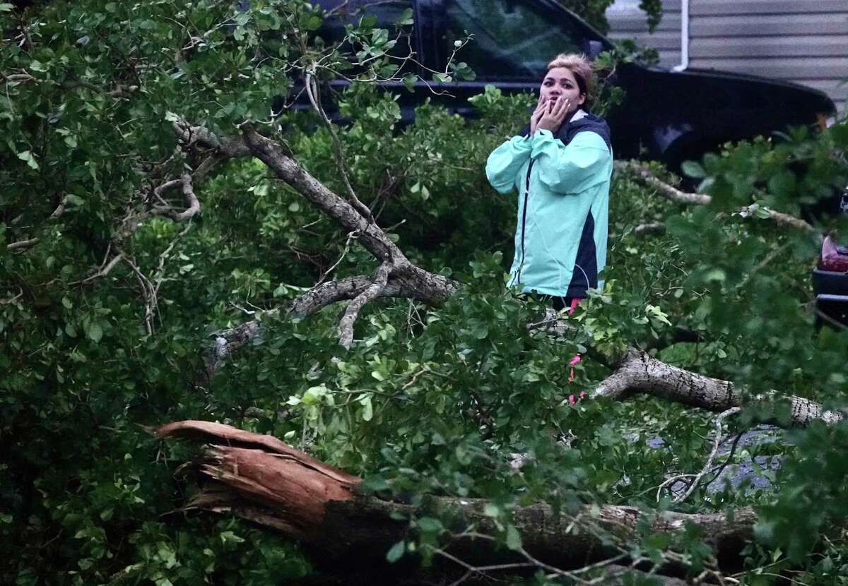 Zuram Rodriguez surveys the damage around her mobile home in Davie, Fla., early Wednesday, Sept. 28, 2022. Hurricane Ian rapidly intensified off Florida's southwest coast Wednesday morning, gaining top winds of 155 mph (250 kph), just shy of the most dangerous Category 5 status. (Joe Cavaretta/South Florida Sun-Sentinel via AP)