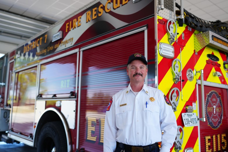 Bexar County District 7 Fire Chief Kevin Clarkson in front of a fire truck in Station 115.
