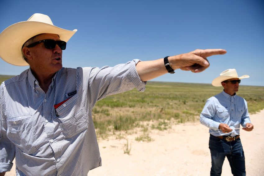 Lynn Cowden, left, points to places around his family ranch property, Sunday, July 7, 2024, at Breezy Point Ranch in Pampa, Texas. During the wildfires, the Cowdens had to transport their cattle to other parts of the country.