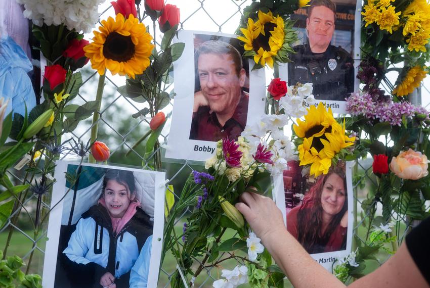 Community members add flowers to a memorial honoring victims of the flood in Kerrville, Texas on Wednesday July 9, 2025.